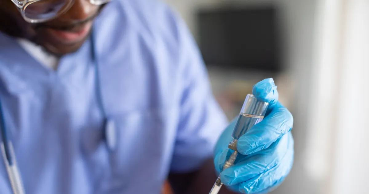A healthcare worker preparing a vaccine